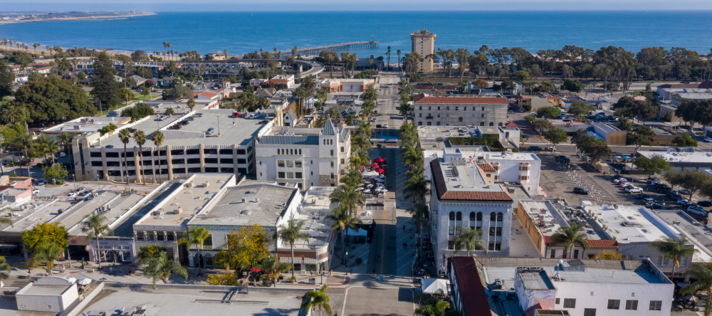 A birds-eye view of Ventura County, CA with the city buildings in the foreground and the ocean in the background.